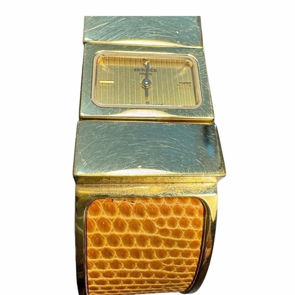 Hermes Loquet Bangle Watch with Brown Orange Lizard Leather band. Gold plated.